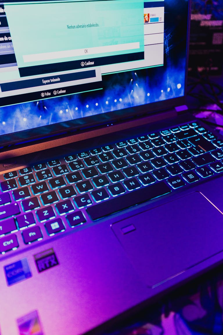 Colorful gaming laptop with illuminated keyboard displaying a game screen, perfect for technology and gaming enthusiasts.
